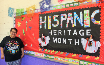 Ms. Davila Standing with her Hispanic Heritage PosterBoard