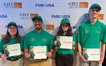 Students posing with their signed certificates